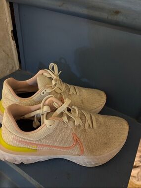 Nike Women's Beige Running Shoes with Pink and Yellow Accents